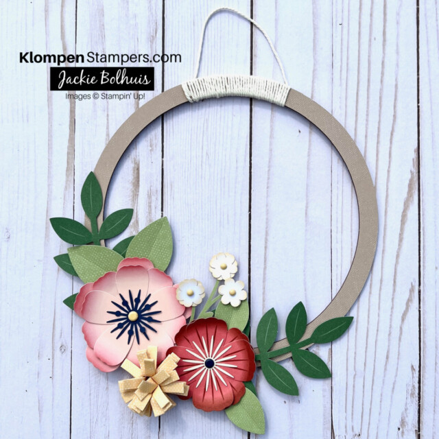 Picture of a paper crafted wreath, designed from using a crafting kit. Wreath has paper flowers with leaves.