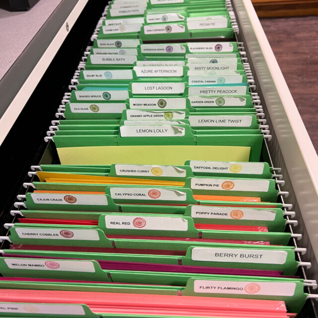open drawer of a lateral filing cabinet showing stampin' up! card stock filed in rainbow color order