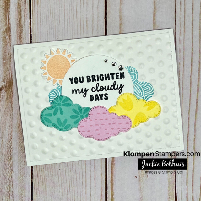 A simple white card that has colorful clouds and a sun on it with a sentiment that reads "you brighten my cloudy days. The card was created with the Stampin' Up! stamp set Bright Skies.